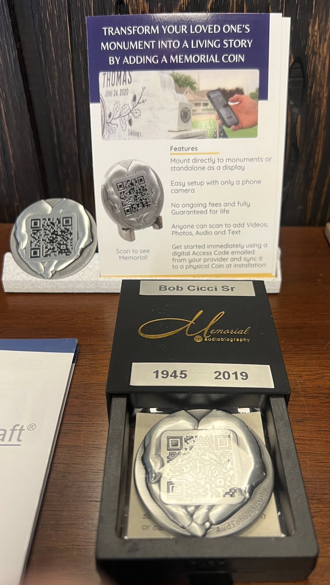 Memorial Coin marketing card showing the product mounted to a monument with its feature list
